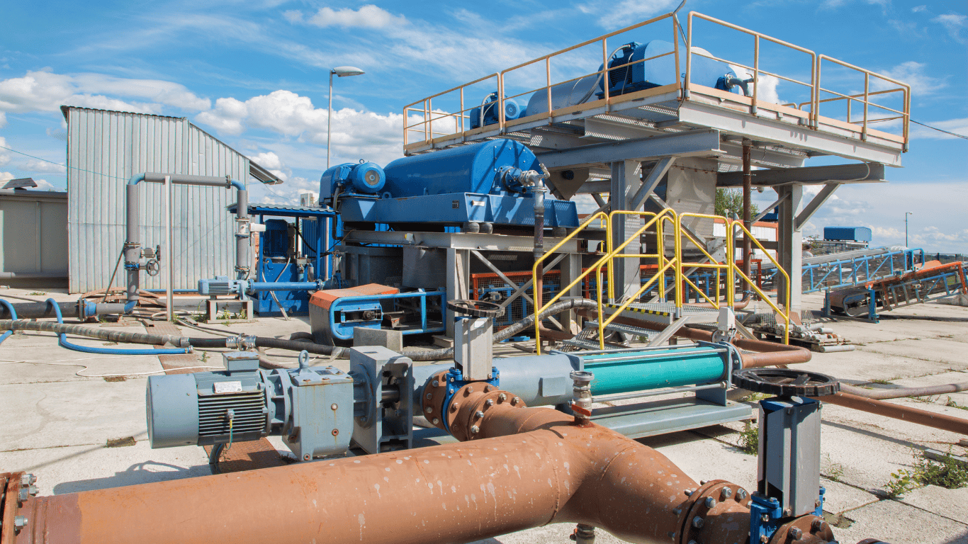 Industrial dewatering systems for biosolids management, showcasing advanced sludge dewatering equipment like centrifuge dewatering, belt press, and screw press. The system is designed for efficient sludge handling, thickening, and biosolids stabilization, with polymer conditioning and odor control. This wastewater treatment facility is part of industrial wastewater solutions, highlighting the importance of wastewater solids management for sustainable biosolids stabilization. Featuring filter press technology for effective biosolid processing, including advanced ProChem Water systems for optimized dewatering performance.